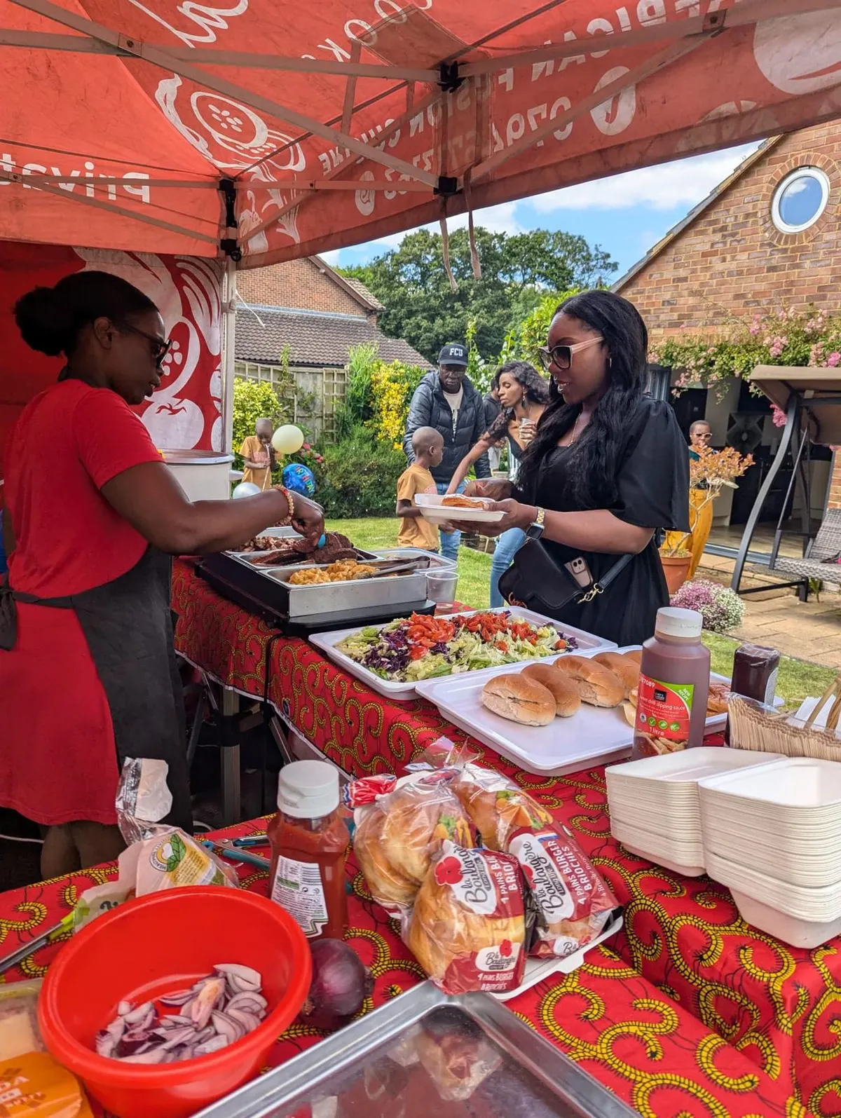 Racheal serving a garden BBQ party
