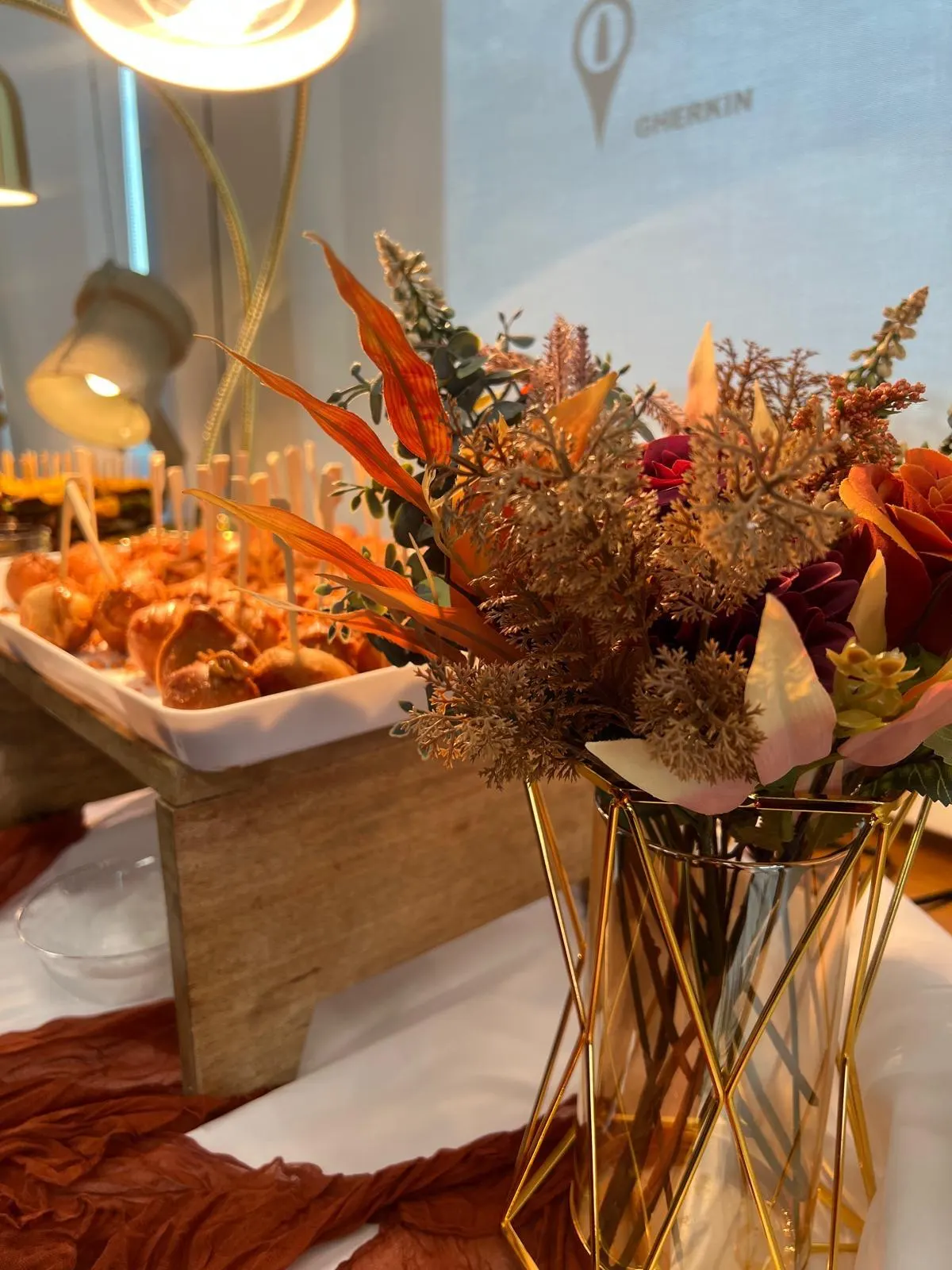 Canapé table styled with flowers in a gold vase
